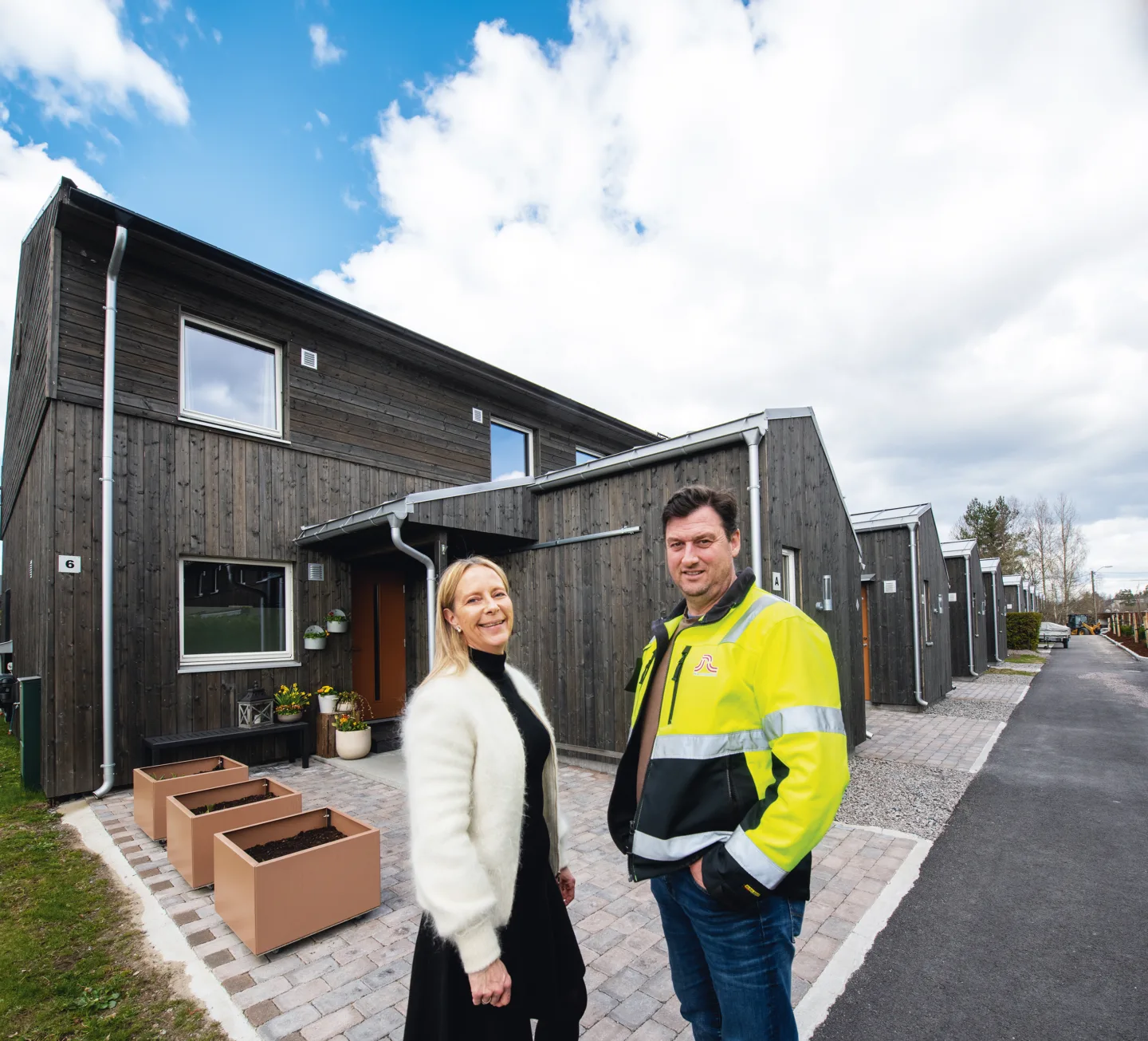 kvinne og mann foran boliger i borettslag